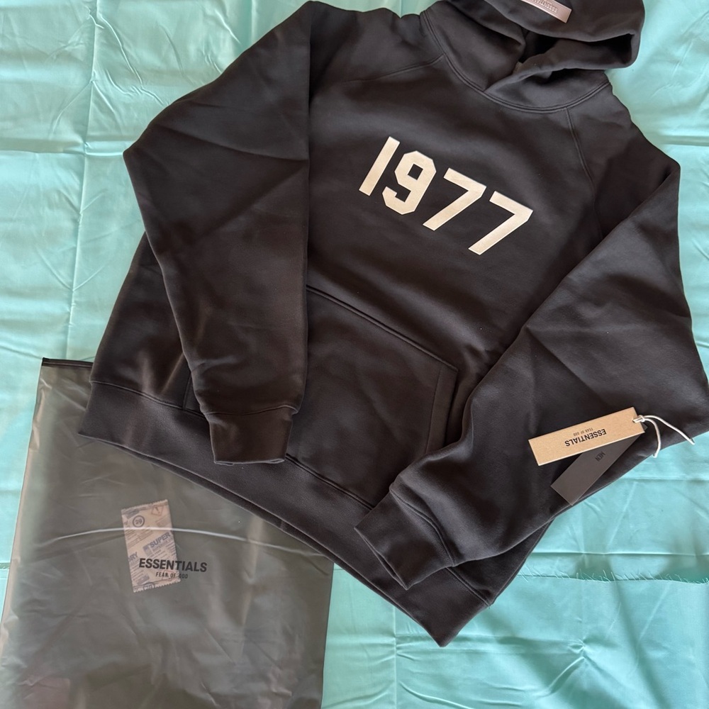 Fear of God Essentials “Iron” Hoodie with 1977 Print